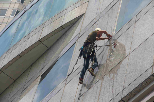 About Our Commercial Exterior Cleaning Services : A man fixing marbel